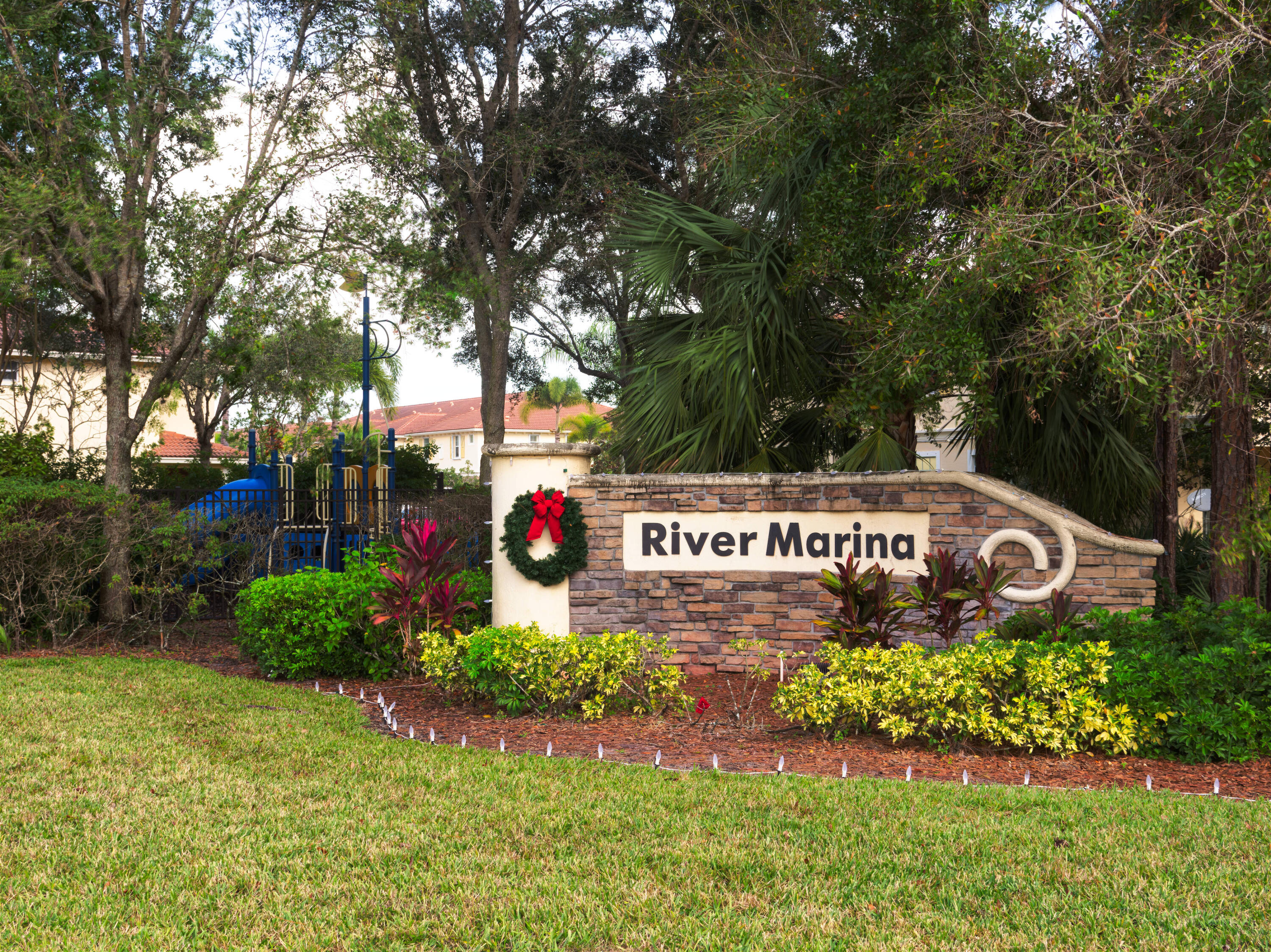 9674 Southwest Purple Martin Way Stuart, FL 34997 - Photo 21 of 21 a sign that is sitting on a brick wall