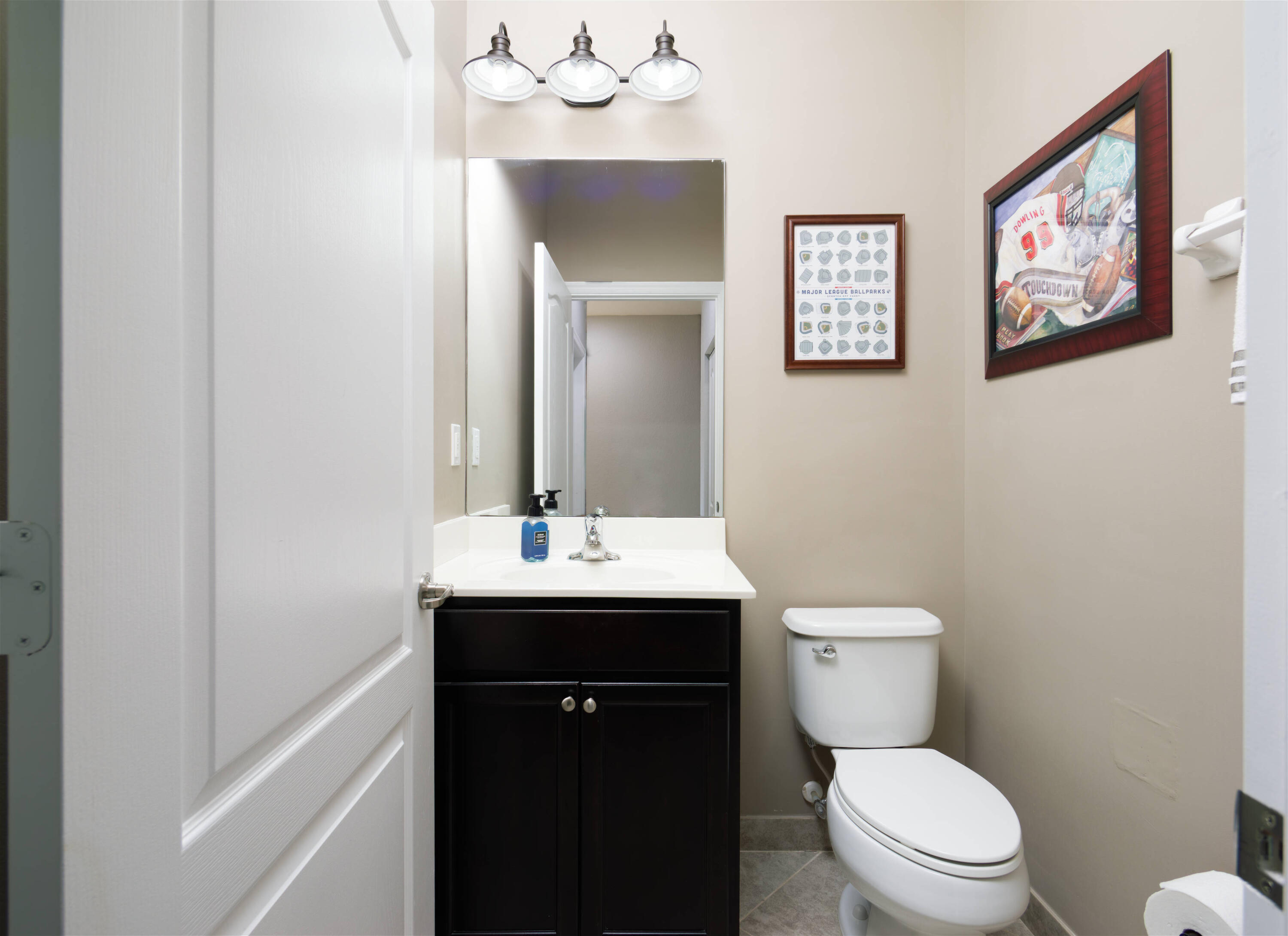 9674 Southwest Purple Martin Way Stuart, FL 34997 - Photo 6 of 21 a bathroom with a toilet a sink and mirror