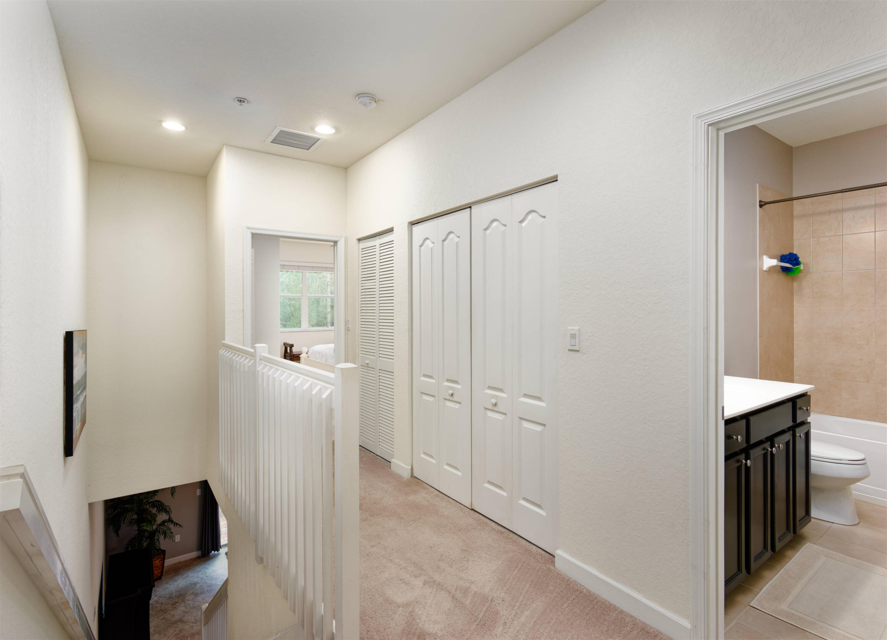 9674 Southwest Purple Martin Way Stuart, FL 34997 - Photo 7 of 21 a view of a hallway with closet and bathroom