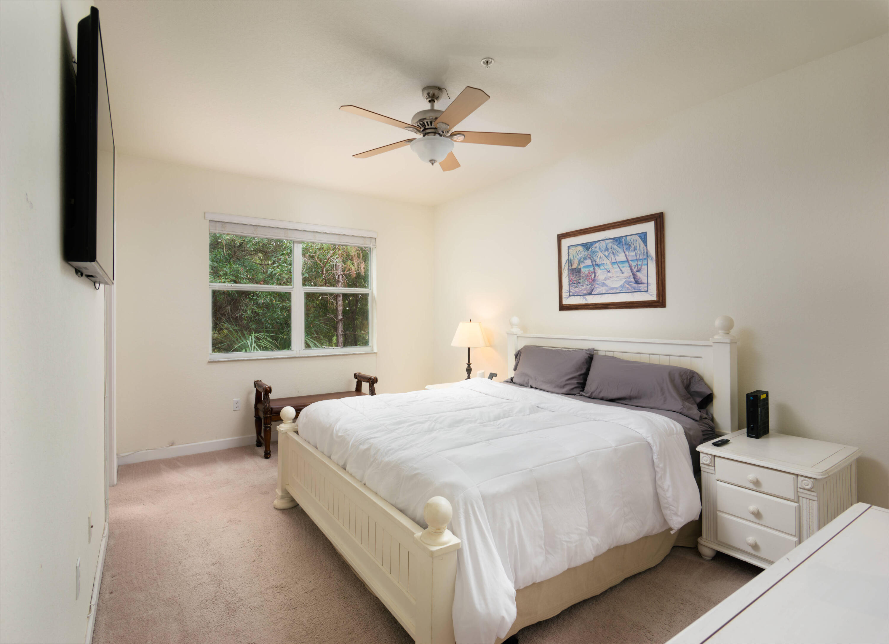 9674 Southwest Purple Martin Way Stuart, FL 34997 - Photo 8 of 21 a spacious bedroom with a bed and window