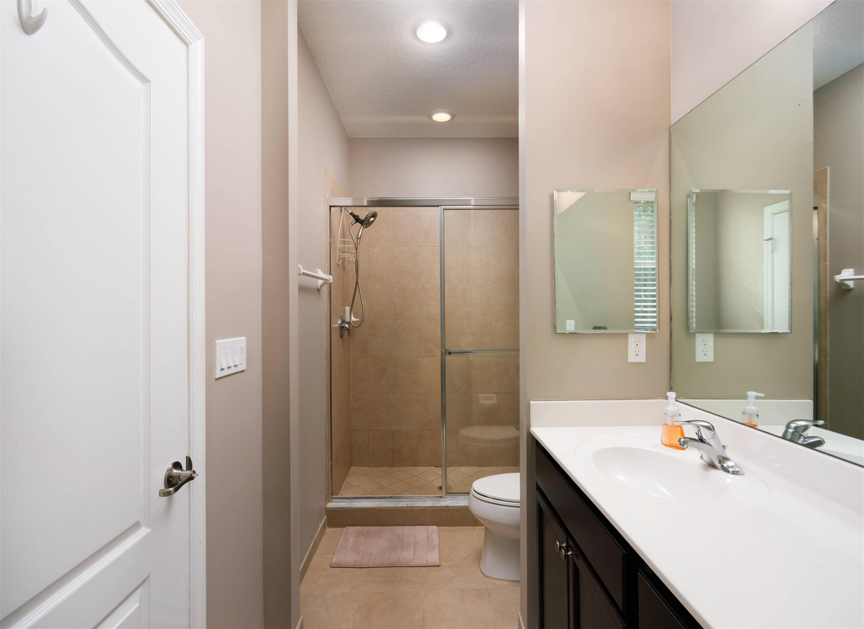 9674 Southwest Purple Martin Way Stuart, FL 34997 - Photo 9 of 21 a bathroom with a sink a toilet and shower