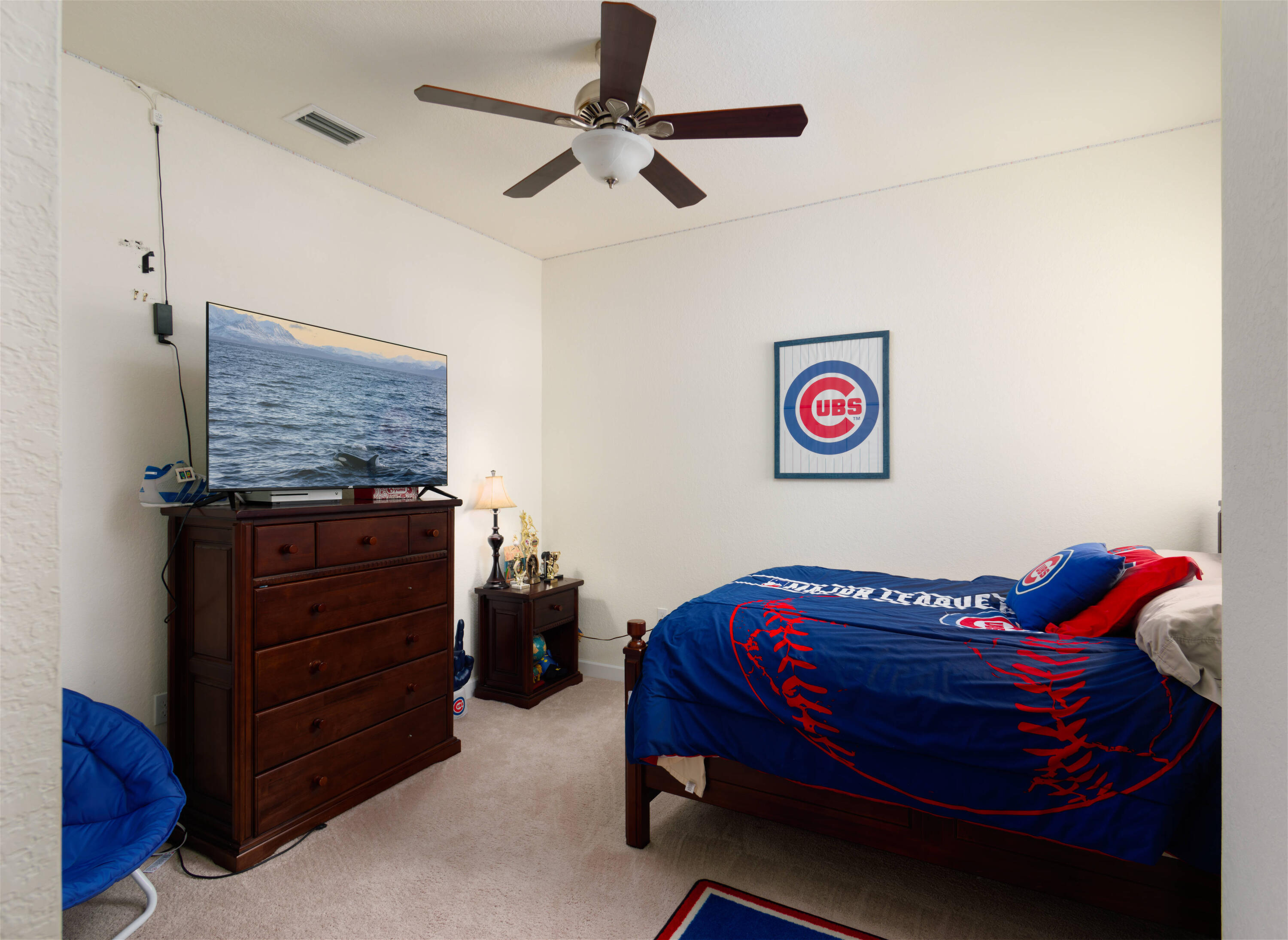 9674 Southwest Purple Martin Way Stuart, FL 34997 - Photo 10 of 21 a bedroom with a bed and a dresser