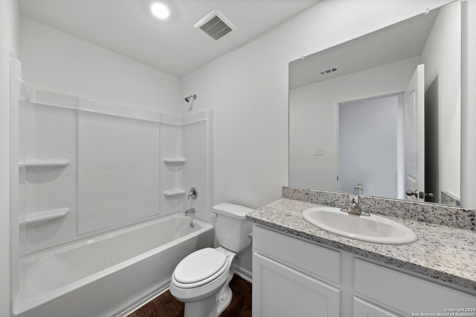 16024 Stratford Cove Lytle, TX 78052 - Photo 14 of 27 a bathroom with a granite countertop sink toilet and shower