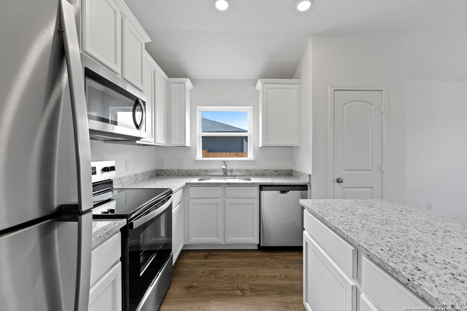 16024 Stratford Cove Lytle, TX 78052 - Photo 4 of 27 a kitchen with stainless steel appliances granite countertop a sink stove and refrigerator