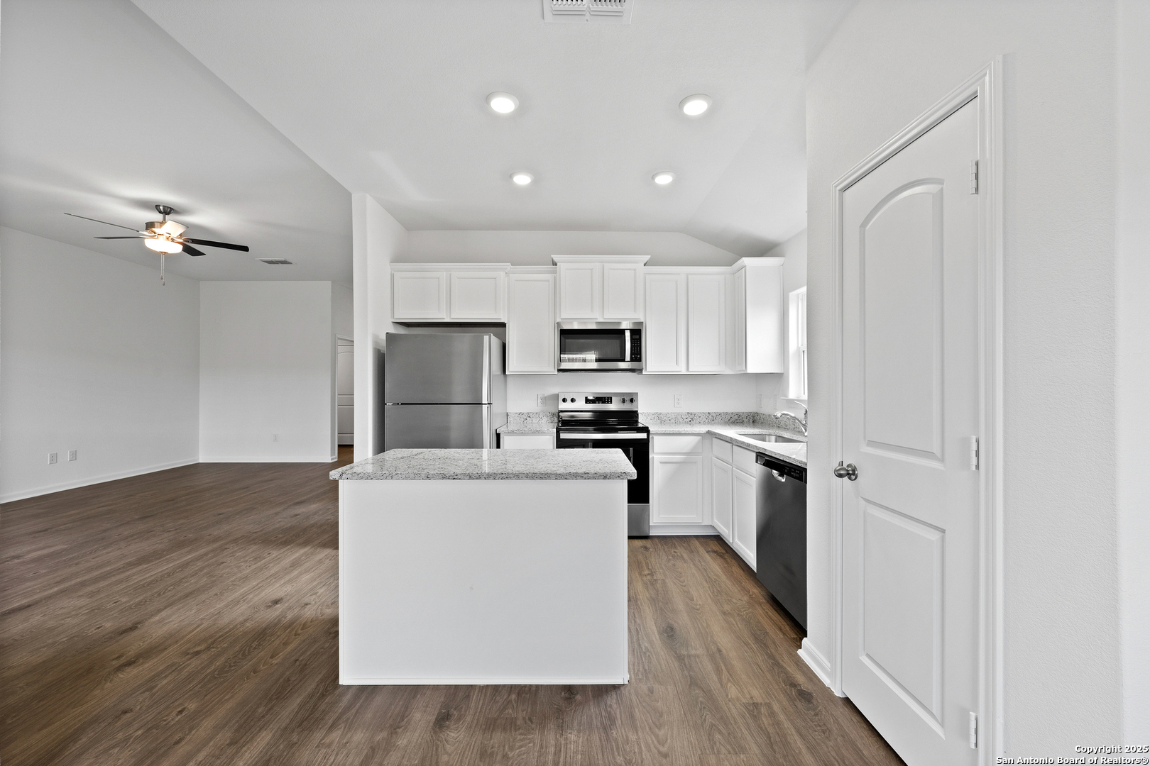16024 Stratford Cove Lytle, TX 78052 - Photo 5 of 27 a kitchen with white cabinets and stainless steel appliances