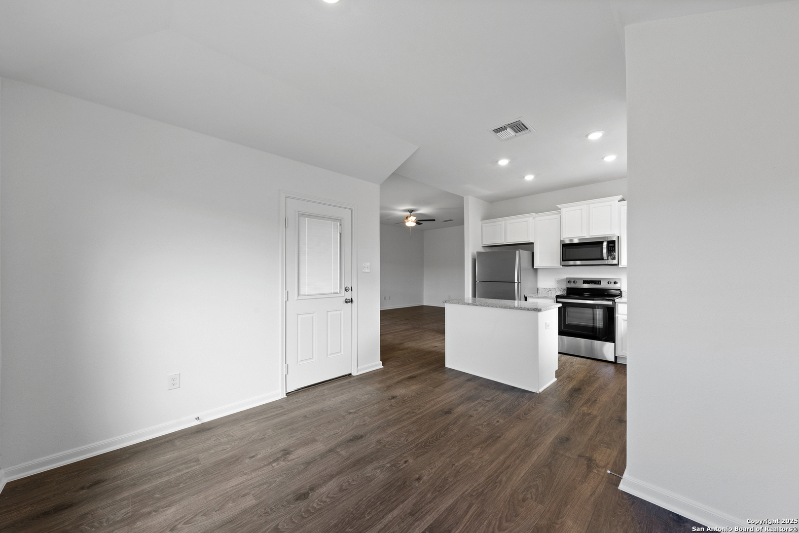 16024 Stratford Cove Lytle, TX 78052 - Photo 6 of 27 a kitchen with a refrigerator and a stove top oven
