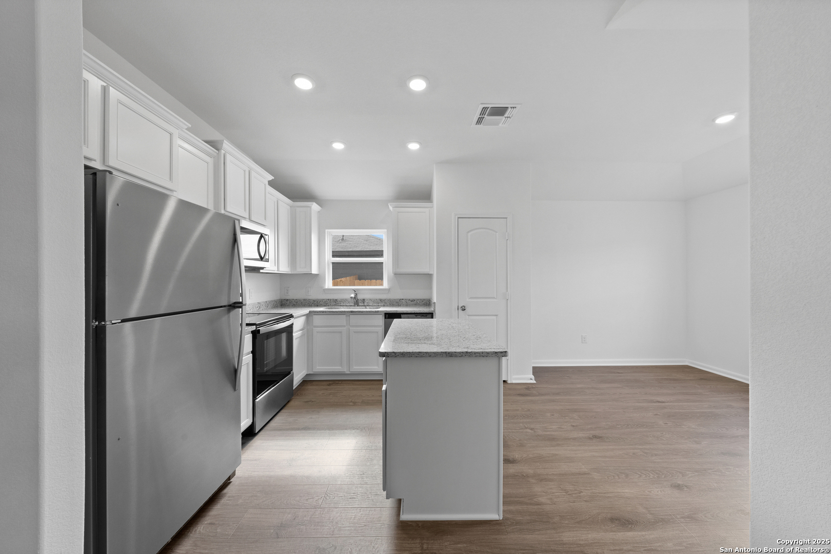 16024 Stratford Cove Lytle, TX 78052 - Photo 8 of 27 a kitchen with stainless steel appliances a refrigerator sink and microwave