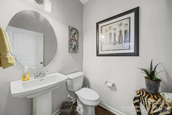 a bathroom with a toilet a sink and mirror