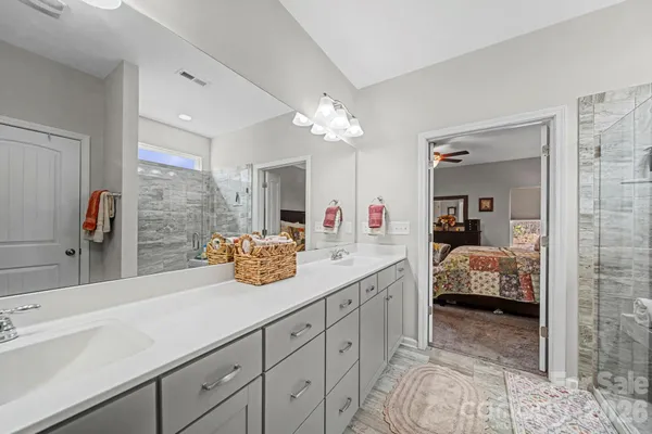 a en suite bathroom with double sink and a mirror
