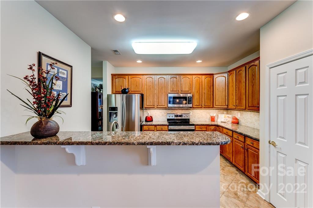 2336 Jade Lane Fort Mill, SC 29708 - Photo 12 of 41 a kitchen with stainless steel appliances granite countertop a refrigerator a sink and a stove