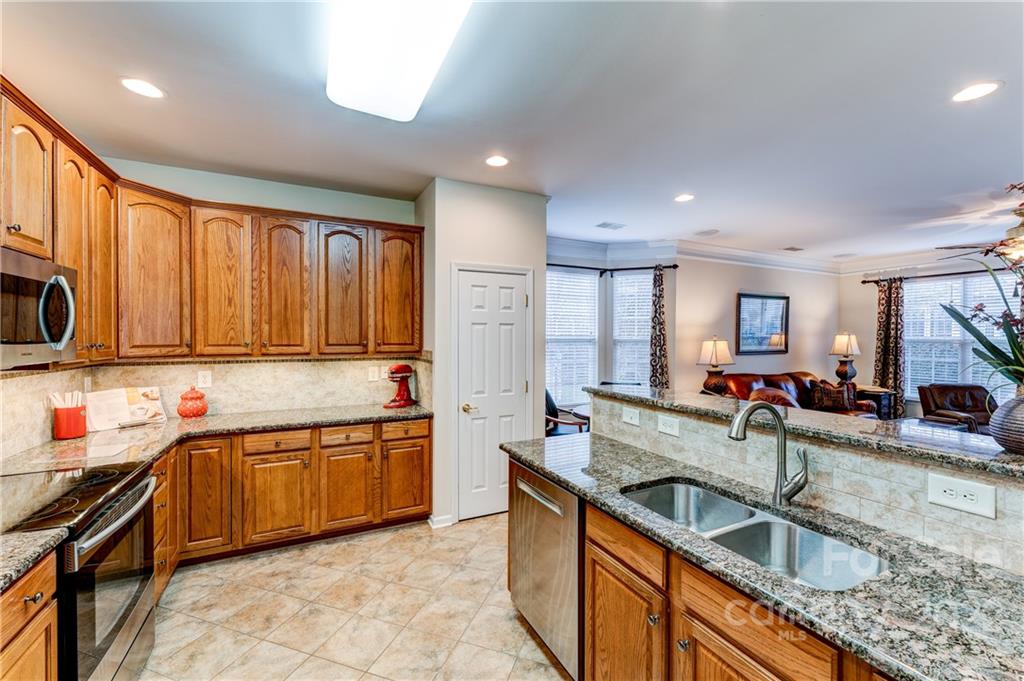 2336 Jade Lane Fort Mill, SC 29708 - Photo 14 of 41 a kitchen with stainless steel appliances granite countertop a sink stove and cabinets