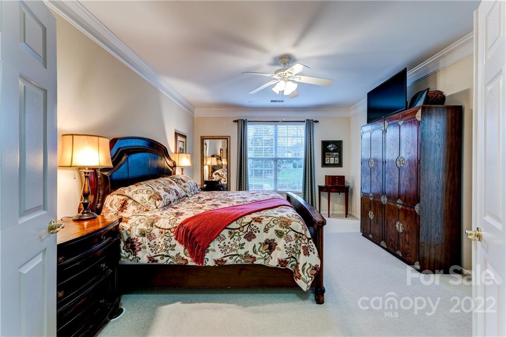 2336 Jade Lane Fort Mill, SC 29708 - Photo 18 of 41 a bedroom with a large bed and a chandelier
