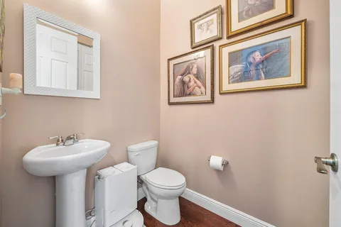 a bathroom with a toilet sink and mirror