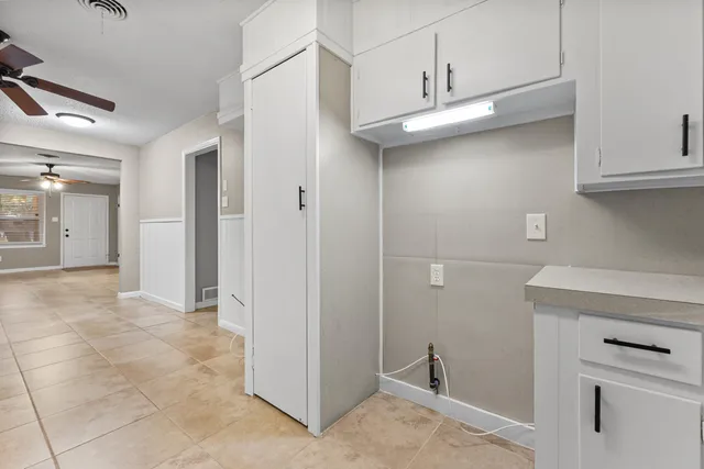 a view of a kitchen with refrigerator and cabinet