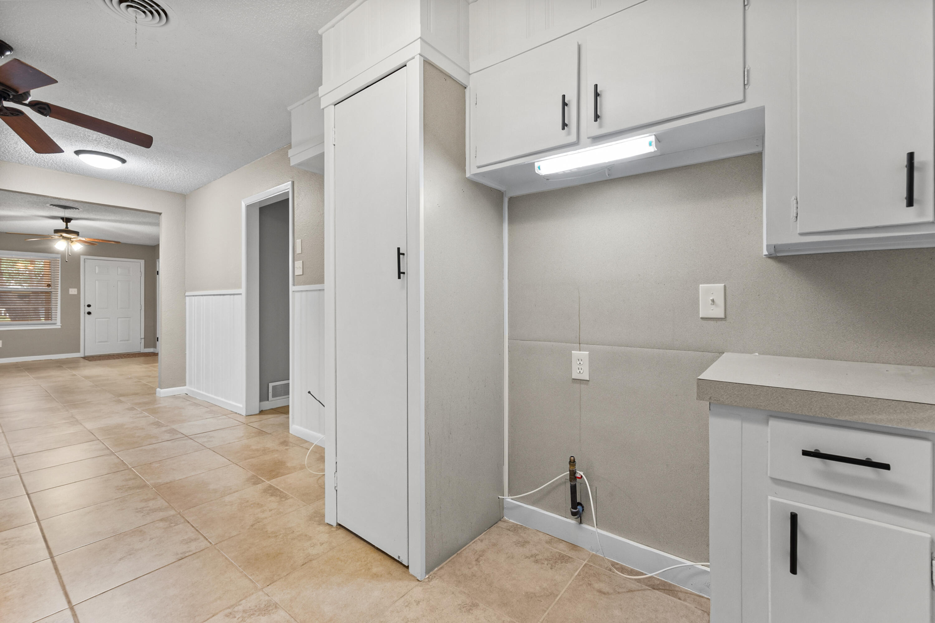 4915 11th Street Lubbock, TX 79416 - Photo 11 of 28 a view of a kitchen with refrigerator and cabinet