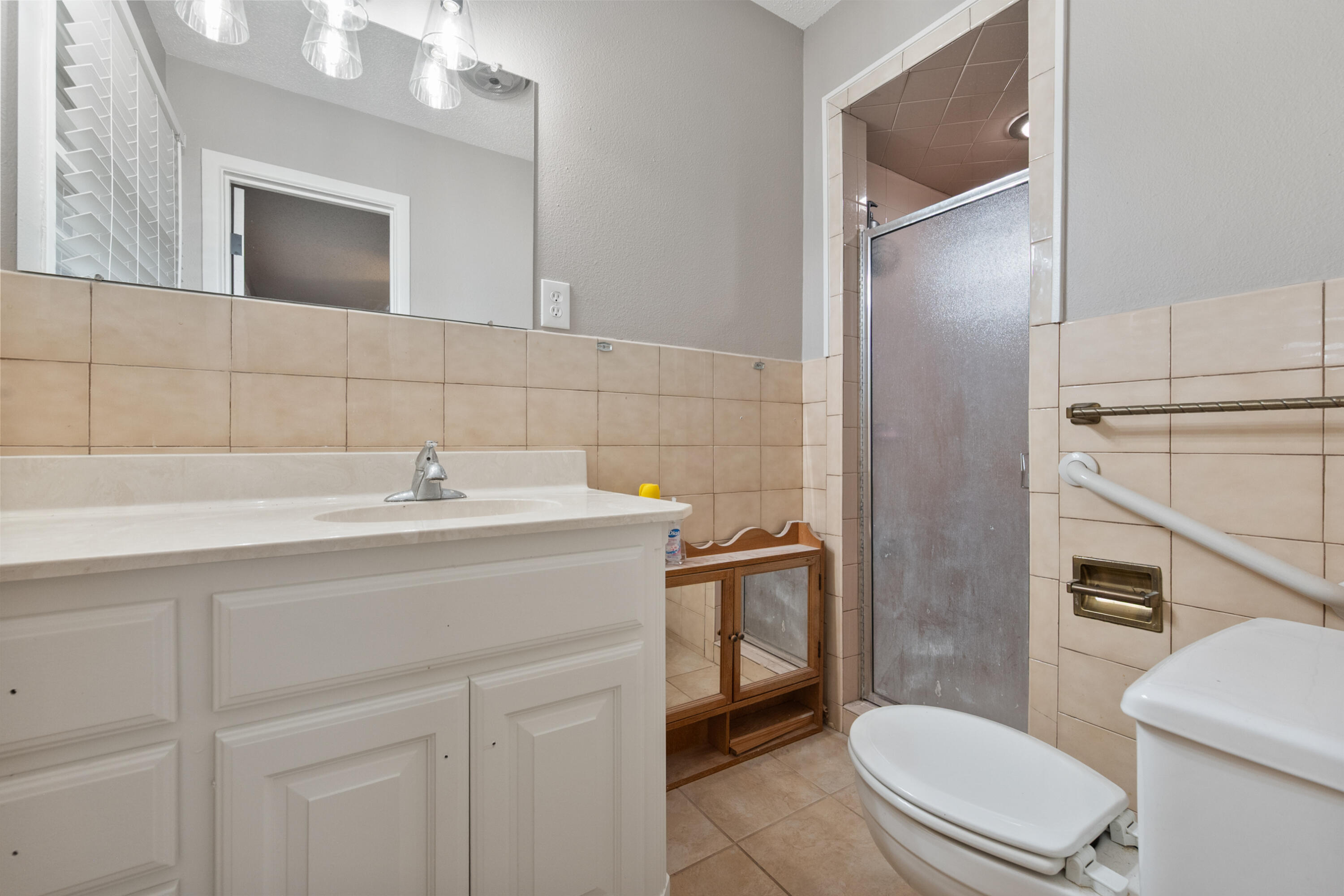 4915 11th Street Lubbock, TX 79416 - Photo 20 of 28 a bathroom with a sink toilet and shower