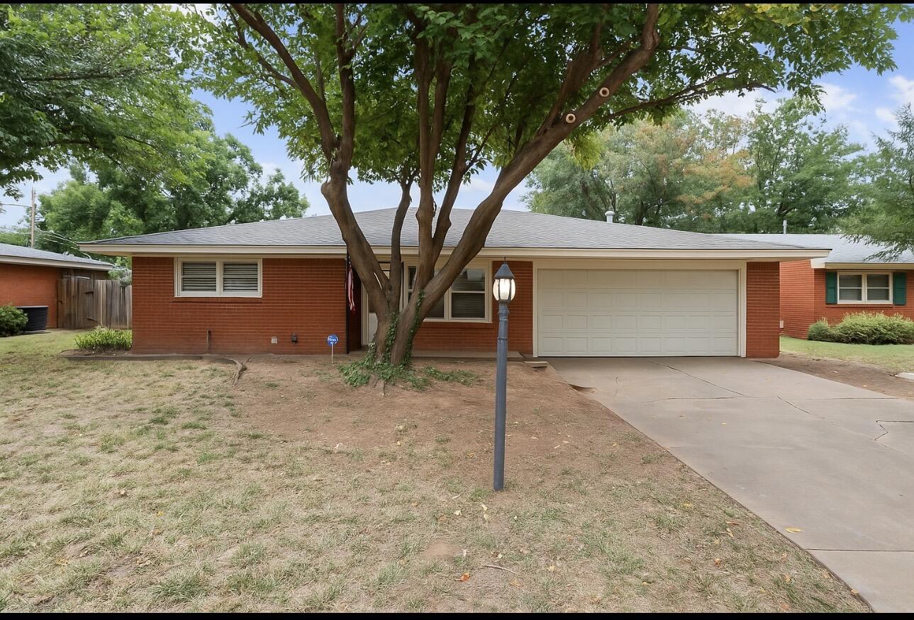 4915 11th Street Lubbock, TX 79416 - Photo 2 of 28 a house with trees in the background