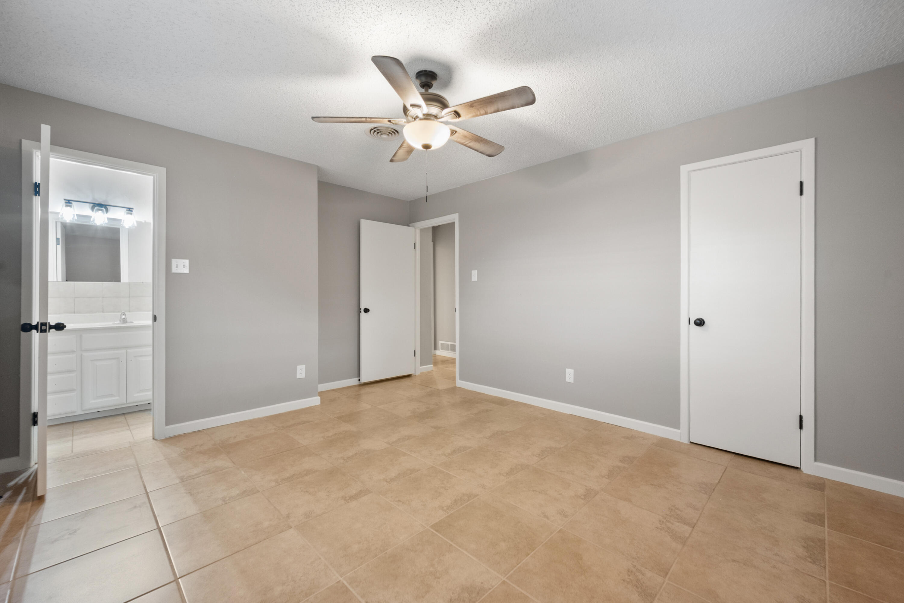4915 11th Street Lubbock, TX 79416 - Photo 21 of 28 a view of an empty room with a ceiling fan