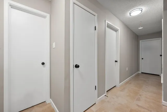 a view of hallway with closet area