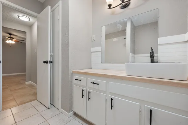a bathroom with a double vanity sink and mirror