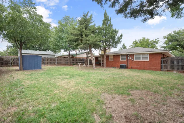a view of house with backyard space and seating area