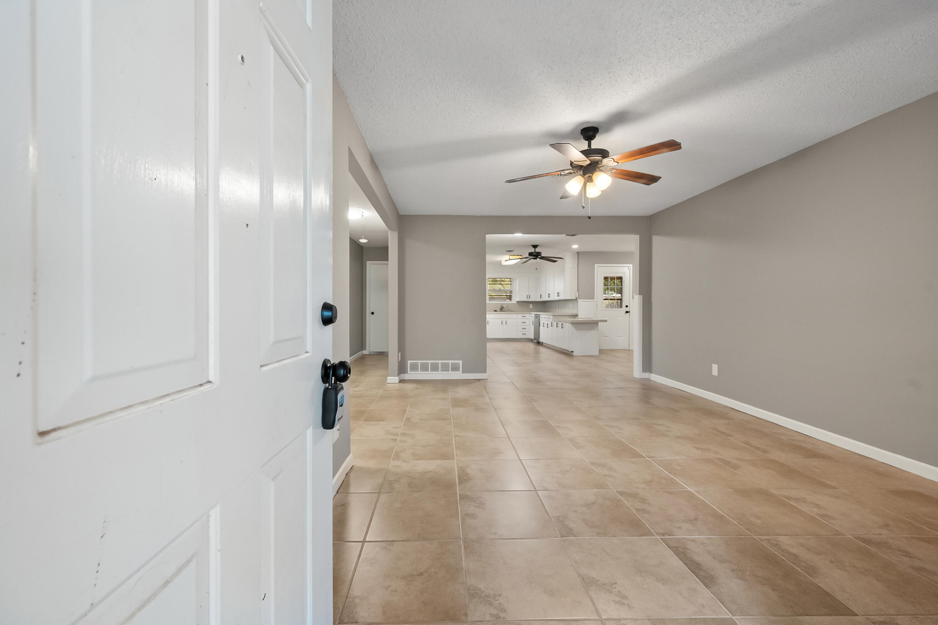 4915 11th Street Lubbock, TX 79416 - Photo 3 of 28 a view of a livingroom with a chandelier fan and windows