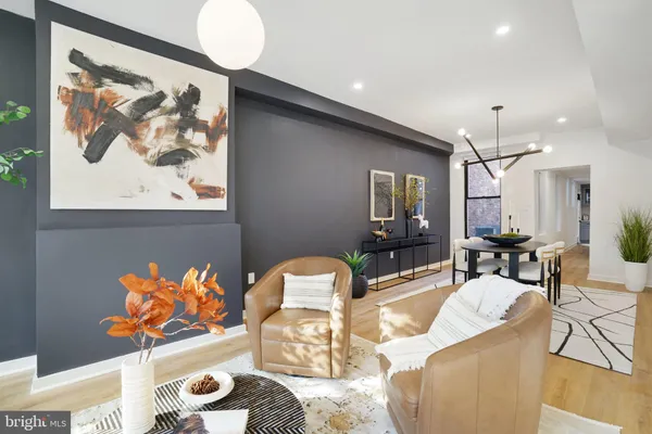 a living room with furniture and a painting on the wall