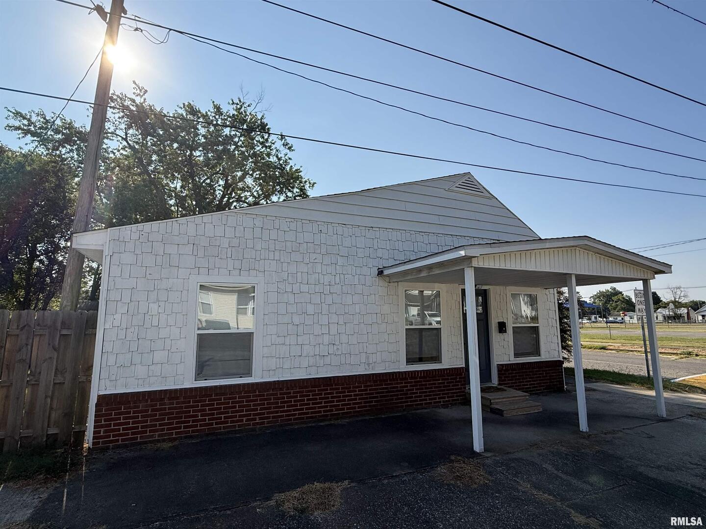 1100 Catherine Street Metropolis, IL 62960 - Photo 4 of 64 a roof deck with a table and chairs under an umbrella