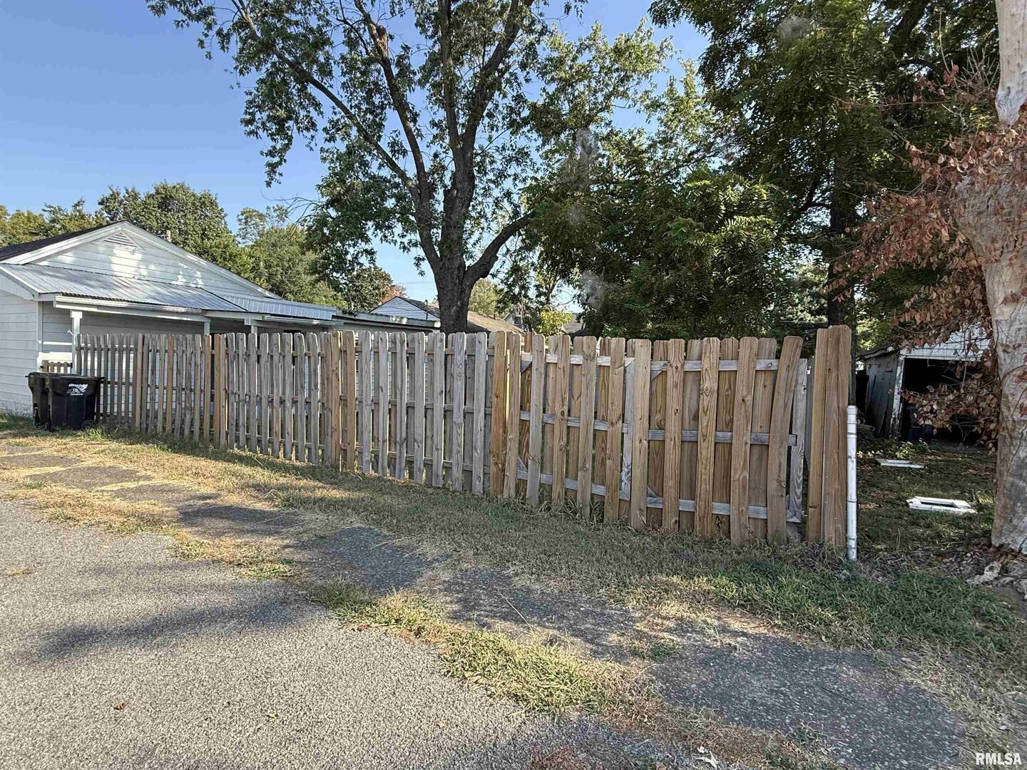 1100 Catherine Street Metropolis, IL 62960 - Photo 62 of 64 a view of a backyard with wooden fence and a large tree