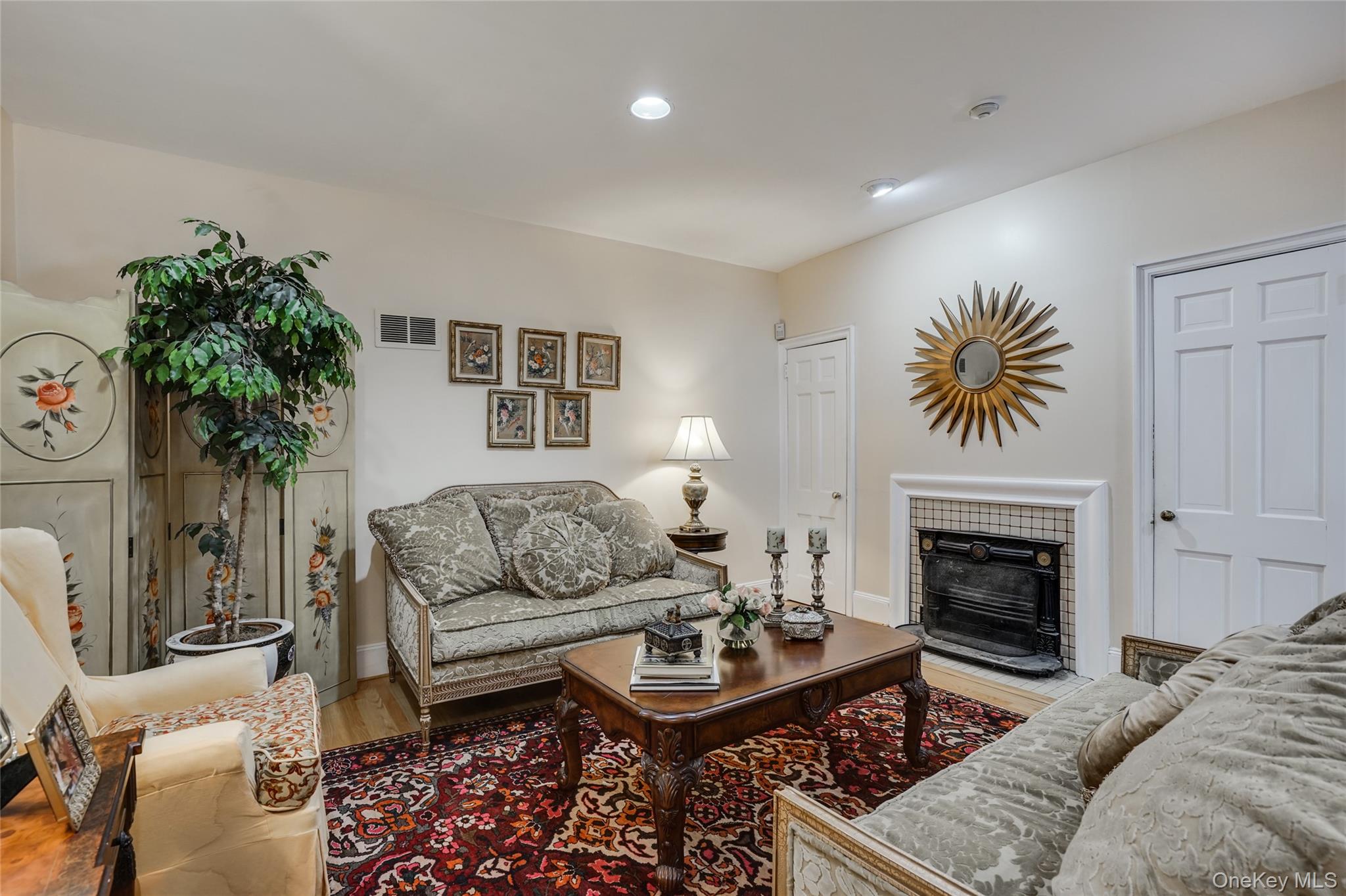 274 River Road St. James, NY 11780 - Photo 9 of 30 a living room with furniture a fireplace and a potted plant