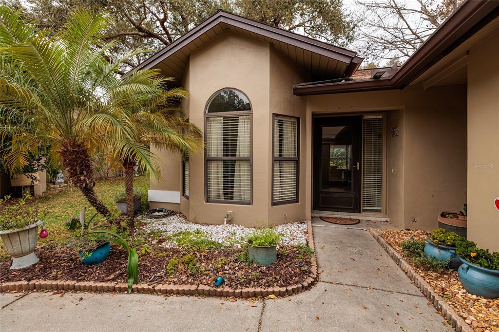 1696 Fry Court Dunedin, FL 34698 - Photo 3 of 30 a front view of a house with garden