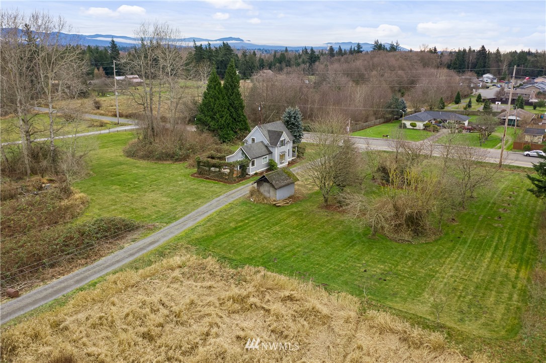 1810 Trigg Road Ferndale, WA 98248 - Photo 16 of 16 a view of a lake with a yard and large trees