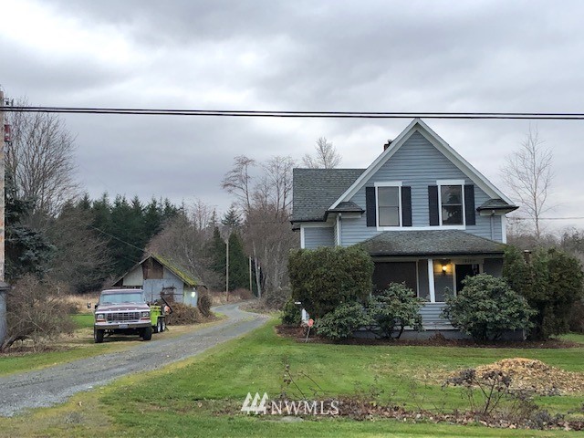 1810 Trigg Road Ferndale, WA 98248 - Photo 3 of 16 a front view of a house with a yard and garage