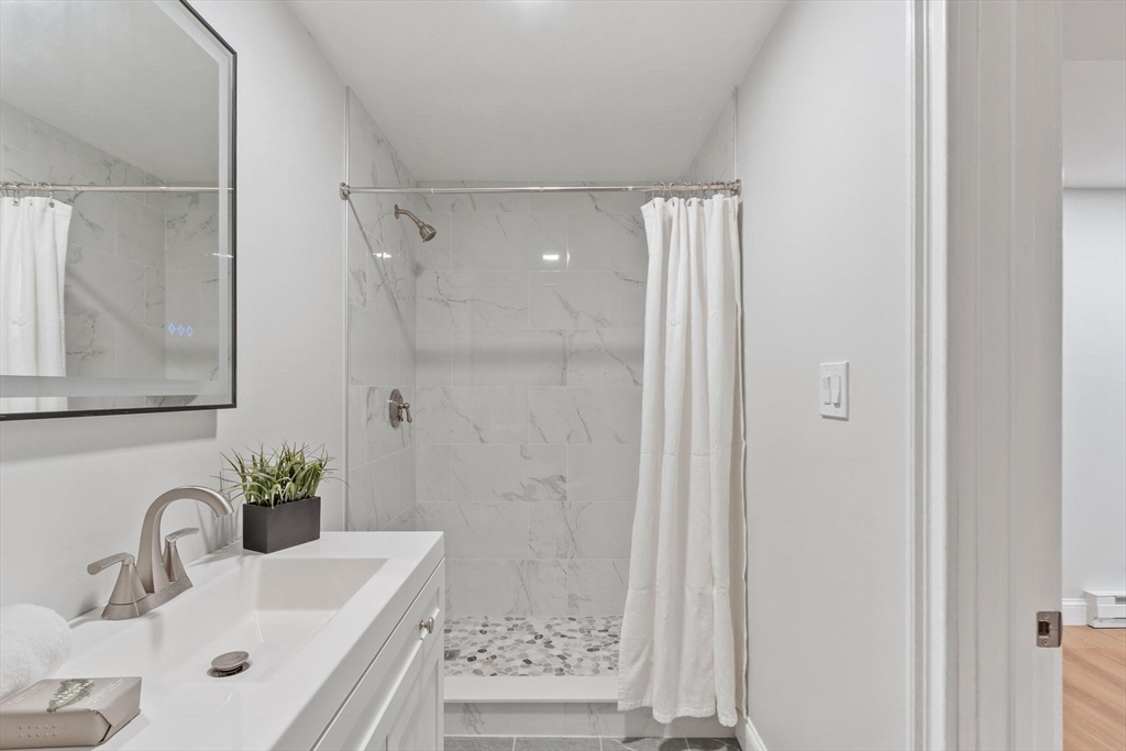 56 Old Marlboro Road Concord, MA 01742 - Photo 21 of 34 a bathroom with a sink and a mirror