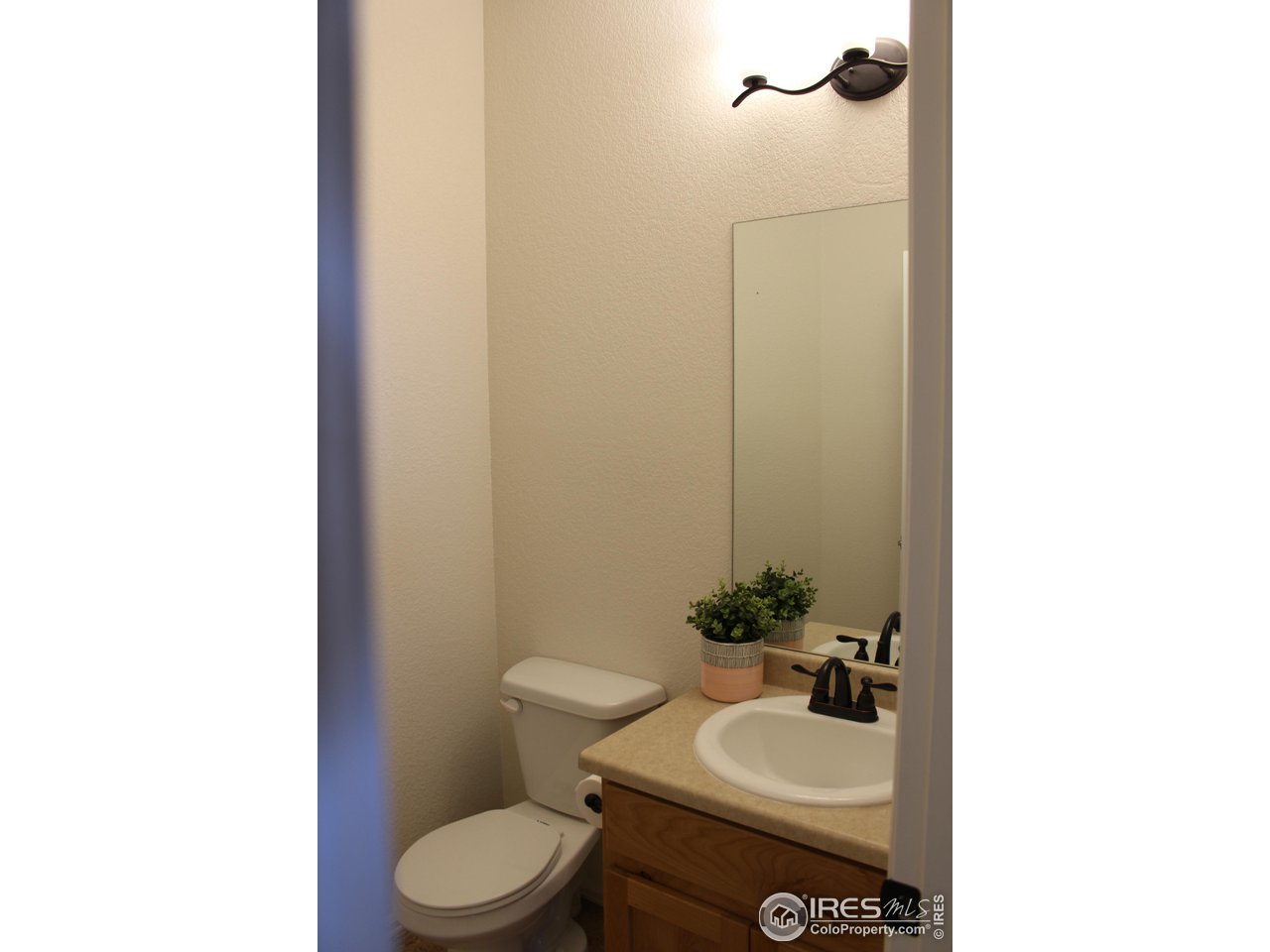 2137 Day Spring Drive Windsor, CO 80550 - Photo 11 of 39 a bathroom with a sink toilet and a mirror