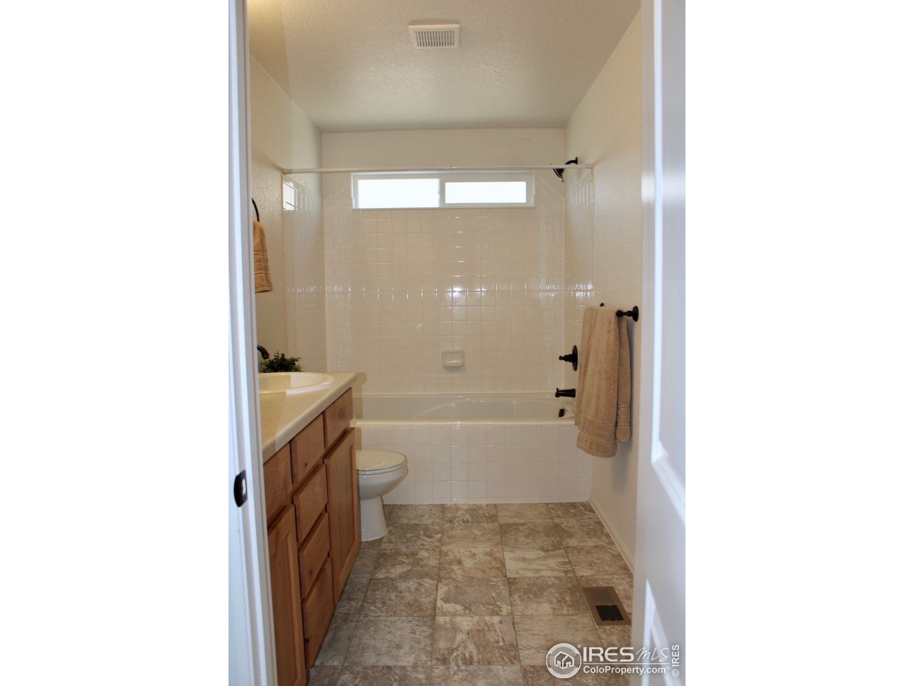 2137 Day Spring Drive Windsor, CO 80550 - Photo 16 of 39 a bathroom with a granite countertop shower mirror and a bathtub