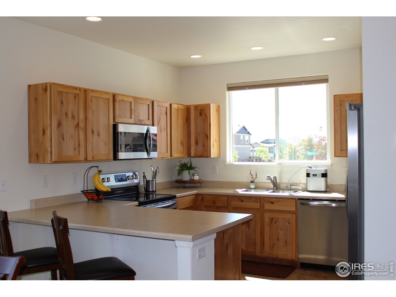 2137 Day Spring Drive Windsor, CO 80550 - Photo 3 of 39 a kitchen with a sink cabinets and window
