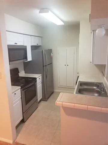 a kitchen with a stove and a refrigerator