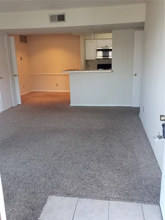 an empty room with a empty space and windows