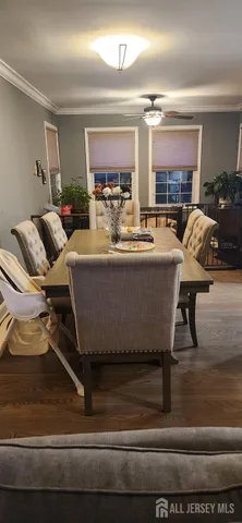 a kitchen with a stove a sink and chairs