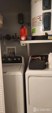 a bathroom with a granite countertop toilet and a sink
