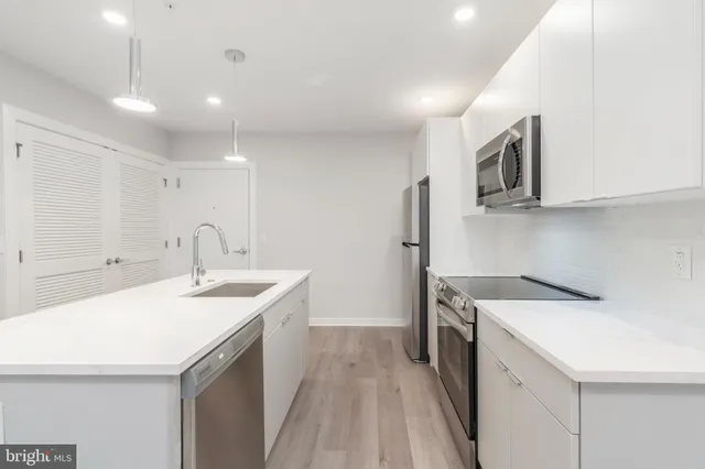 a kitchen with a sink a stove and refrigerator
