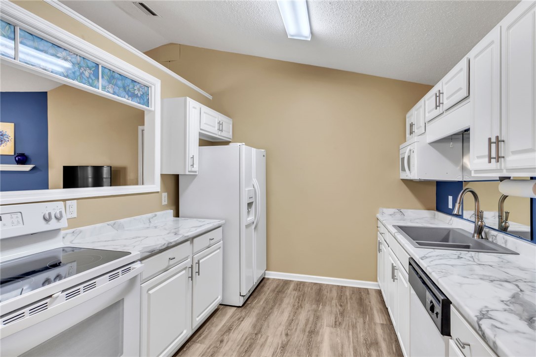 706 Pelham Square Way Greer, SC 29650 - Photo 12 of 20 This kitchen features sleek countertops and ample cabinet space for all your culinary needs.