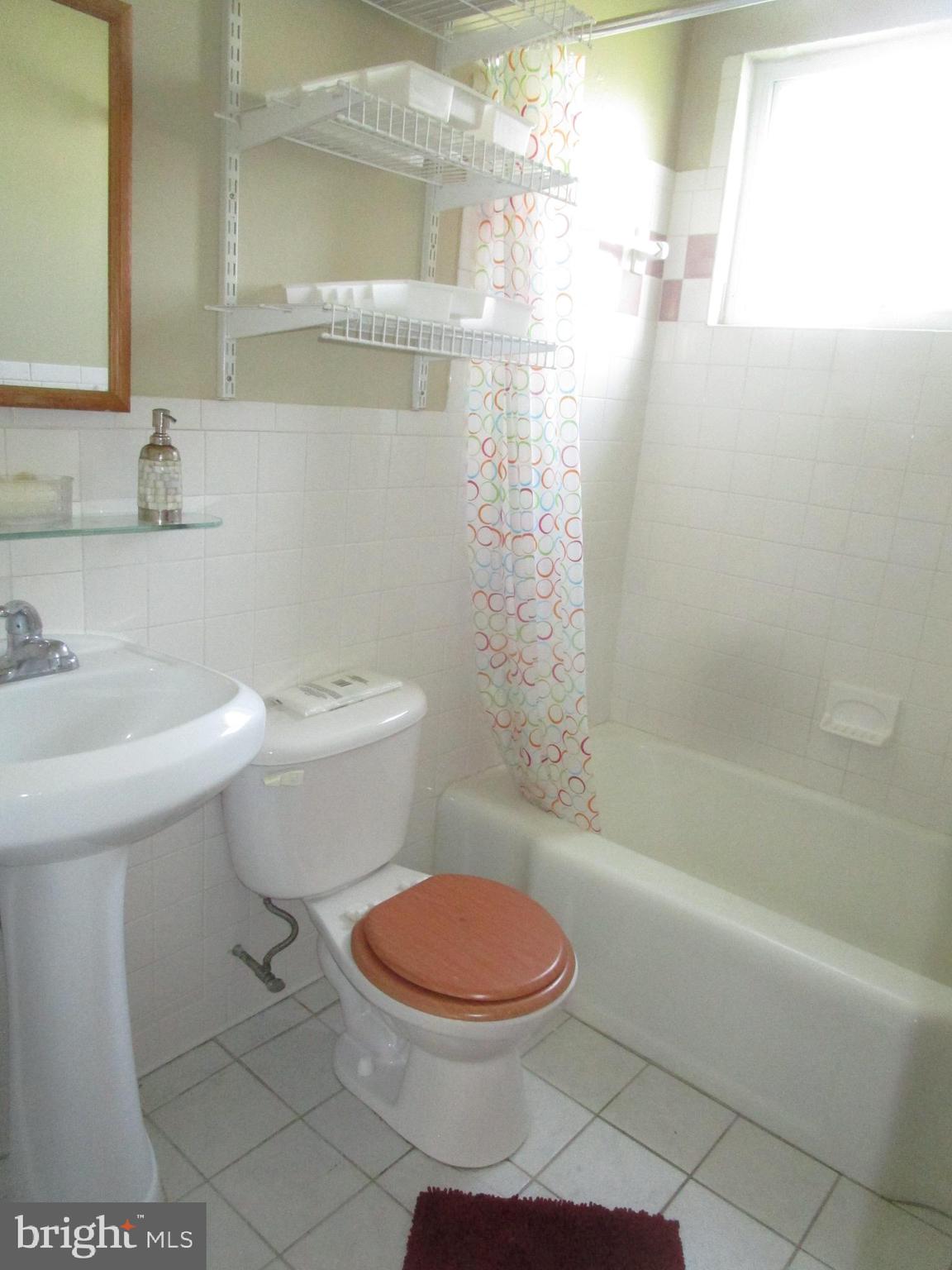 2816 Keating Street, Unit 164 Temple Hills, MD 20748 - Photo 12 of 25 a bathroom with a sink a toilet and shower