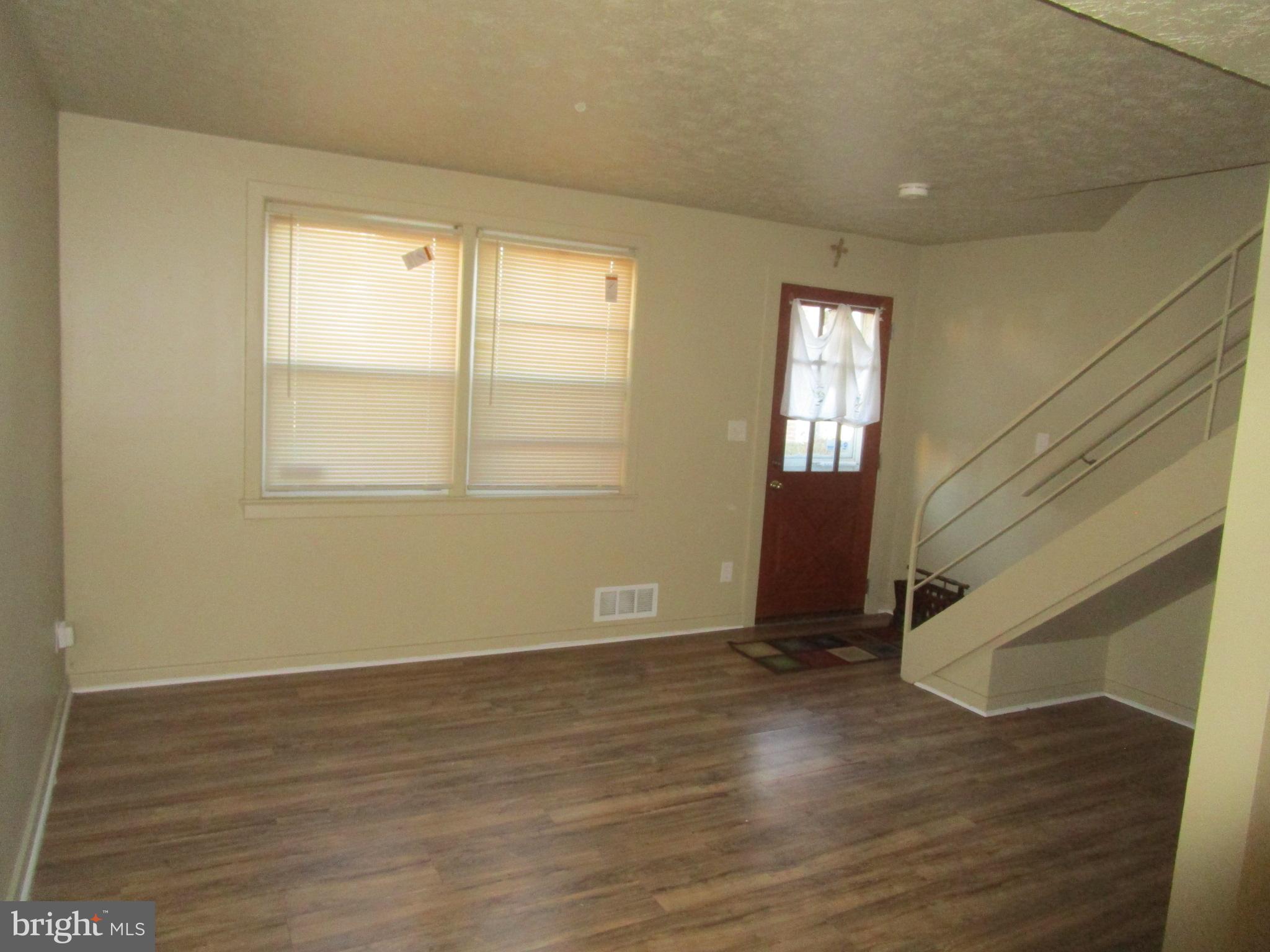 2816 Keating Street, Unit 164 Temple Hills, MD 20748 - Photo 14 of 25 a view of an empty room with wooden floor and a window