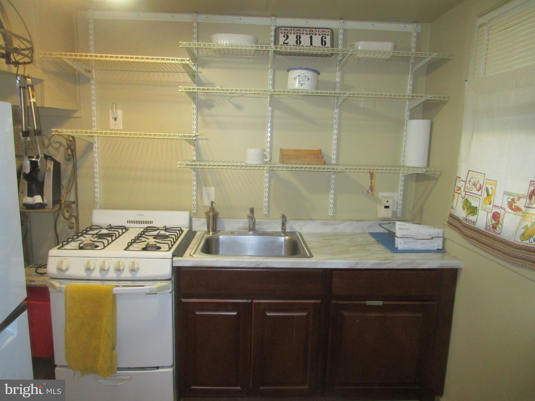2816 Keating Street, Unit 164 Temple Hills, MD 20748 - Photo 17 of 25 a kitchen with a sink stove and cabinets
