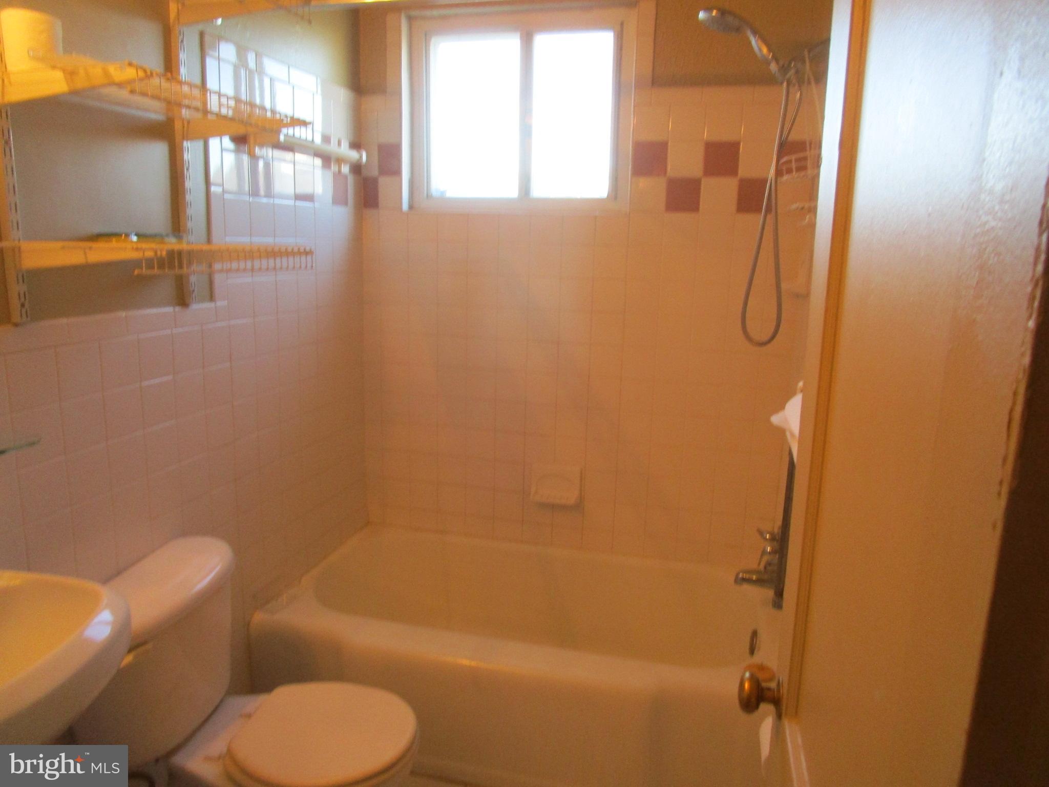 2816 Keating Street, Unit 164 Temple Hills, MD 20748 - Photo 21 of 25 a bathroom with a shower a toilet and a shower