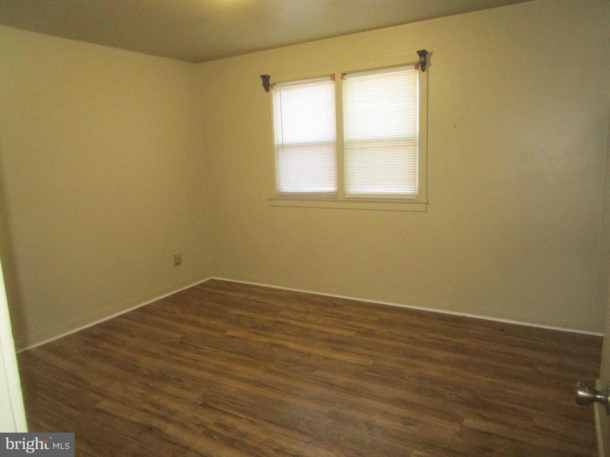 2816 Keating Street, Unit 164 Temple Hills, MD 20748 - Photo 23 of 25 a view of an empty room with wooden floor and a window