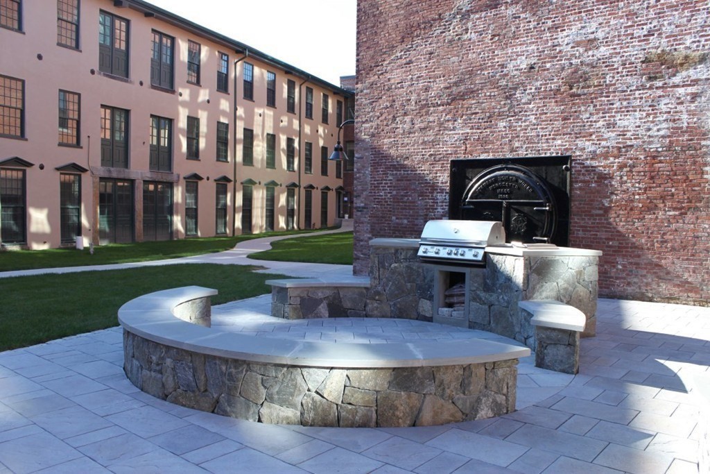 64 Beacon Street, Unit A307 Worcester, MA 01608 - Photo 13 of 23 a view of a patio with couches table and chairs and potted plants