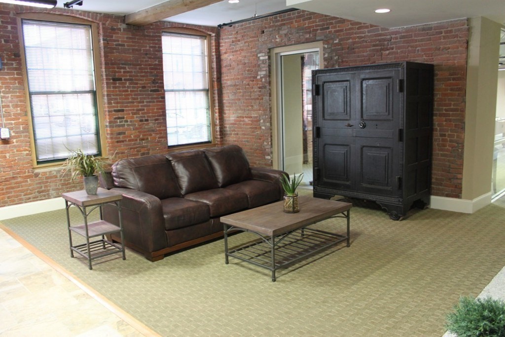 64 Beacon Street, Unit A307 Worcester, MA 01608 - Photo 16 of 23 a living room with furniture and a window